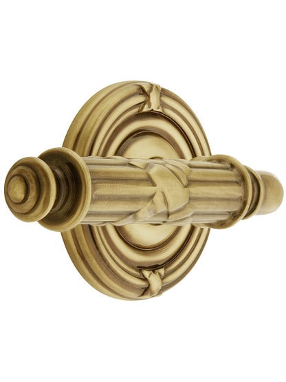 Ribbon and Reed Door Set With Lever Handles Left Hand in Antique Brass.